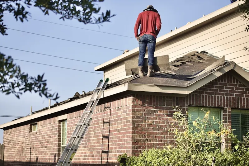 Professional roofer working on a residential roof in Dayspring